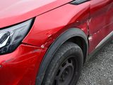 a close up of a red suv parked in a parking lot