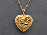 a close up of a heart shaped locke with a bird on it