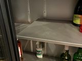 a refrigerator that has a lot of bottles of alcohol in it