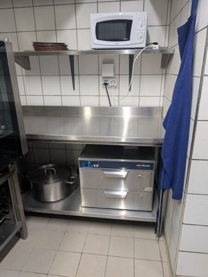 une petite cuisine équipée d'un micro-ondes et d'une cuisinière