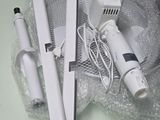 a white hair dryer and a blow dryer sitting on a table