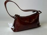 brown leather handbag on a white surface with a white background