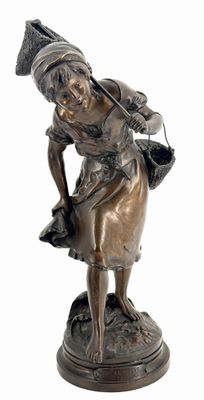 bronze statue of a woman with a basket on her shoulder