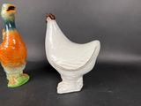 two ceramic figurines of a chicken and a duck