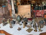 a table that has a lot of antique items on it