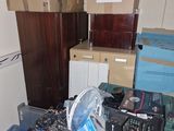 a pile of boxes and a refrigerator in a room