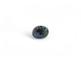 a close up of a blue sapphire stone on a white surface