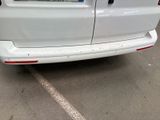 a white van parked in a parking lot next to a building