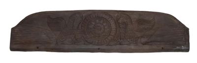 wooden carving of a fish on the side of a wall