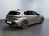 the rear view of a silver car in a showroom