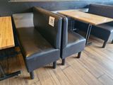 two benches and a table in the corner of a restaurant