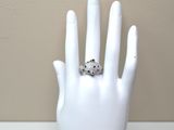 a white mannequin hand with a ring on it