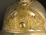 a gold helmet with a crest on the top of it