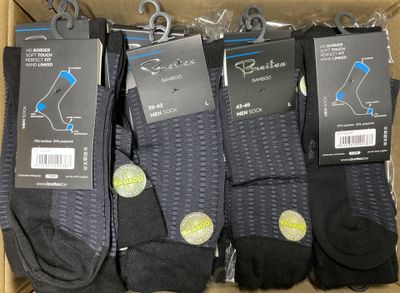 six pairs of men ' s black socks in a box