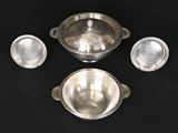 four pieces of silverware sitting on a black surface
