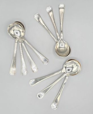 three silver spoons and two silver spoons on a white surface