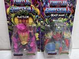 two action figures of the same character are shown in front of a box