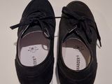 pair of black sued shoes with white soles on a white surface