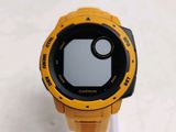 a close up of a yellow and black watch on a stand