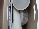 a cardboard box with a cup and a paper plate inside of it