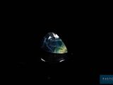 a blue and green diamond on a black surface