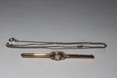 a silver and gold tie bar and a silver and gold tie bar
