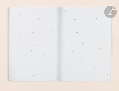 an open book with numbers on it sitting on top of a table