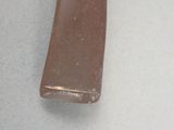 a brown piece of glass on a white surface