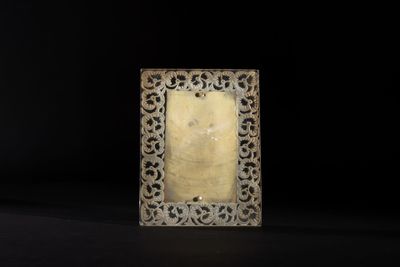 an old silver picture frame with a carved design on it