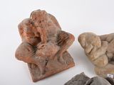 three pieces of pottery sitting on top of a white surface