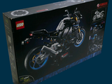 a box with a lego motorcycle in it on a blue background