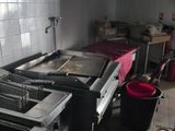 a kitchen with a stove, sink, and other appliances in it
