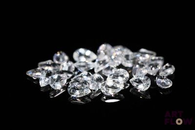 a pile of white diamonds on a black surface
