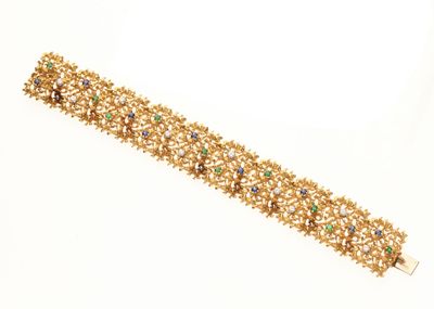 une photo d'un bracelet en or orné de pierres multicolores