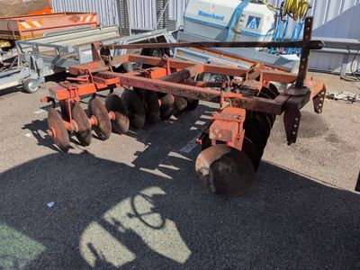 an image of a tractor with a plow attached to it ' s back