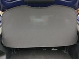 the back of a car with the trunk open and the seat folded down