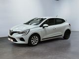 a white car in a white room with a black floor