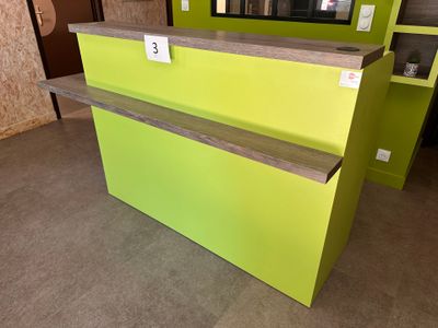 a yellow and green counter with a mirror in the background