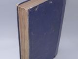 a blue book that is open on a white surface