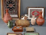 many different pieces of art displayed on the table