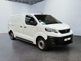 the small white van is parked in a large room