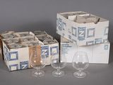 several empty wine glasses are sitting next to a box of empty wine glasses