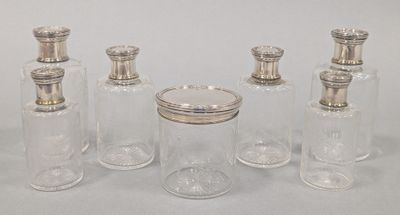 four glass jars with silver lids and silver lids