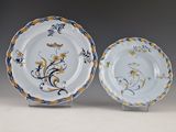 two blue and white plates with floral designs on them on a table