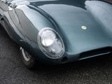 a close up of a green sports car parked in a parking lot