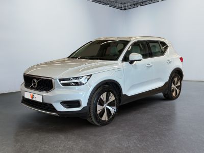 a white volvo suv parked in a large room