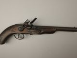 an old gun that is on display on a table