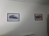 pictures of cars hanging on the wall above a radiator