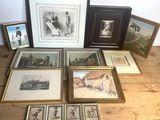 many framed pictures on a wooden table with pictures on it