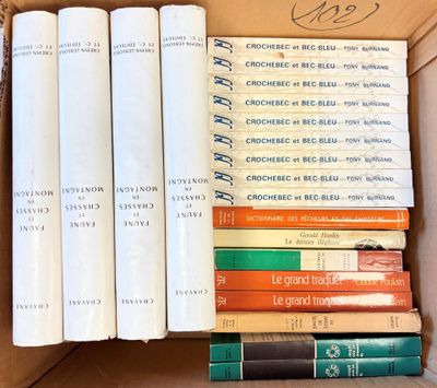 de nombreux livres dans une boîte en carton posée sur la table